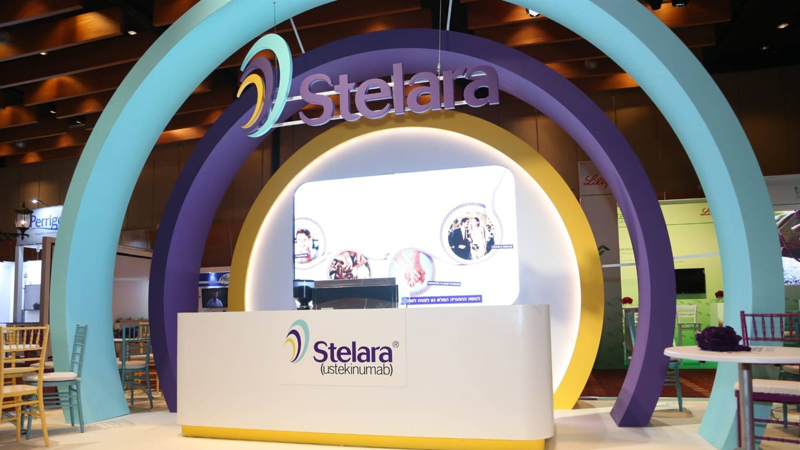 Nested teal, purple and yellow arches framing a glowing circular niche above a white counter.