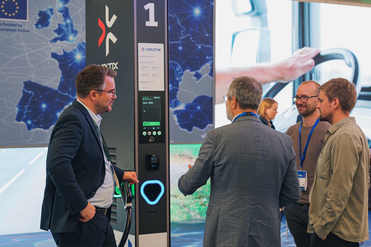 A conversation at the charging station, its connector lit.