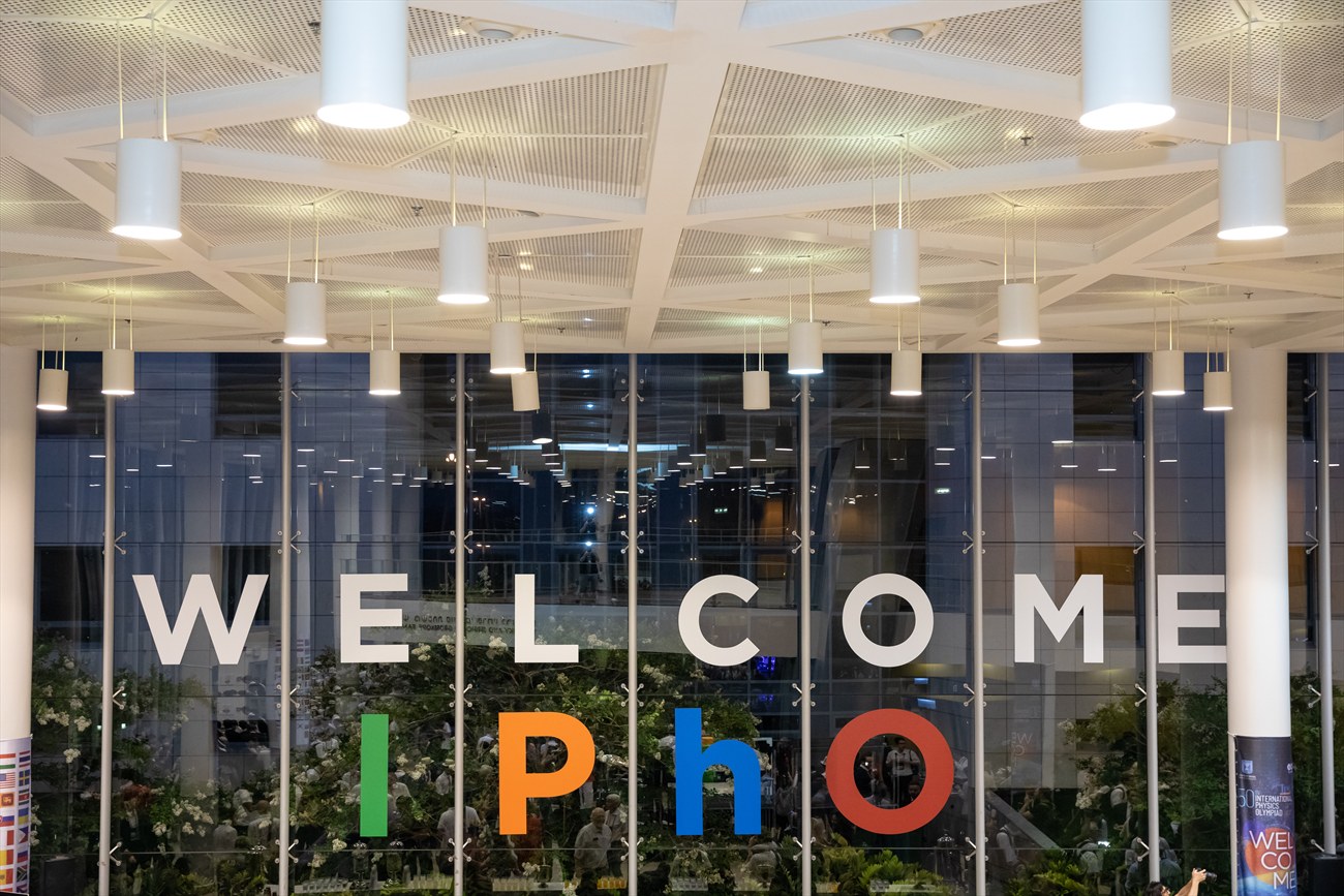 The word WELCOME set in large letters across a glazed facade, with the venue behind it.