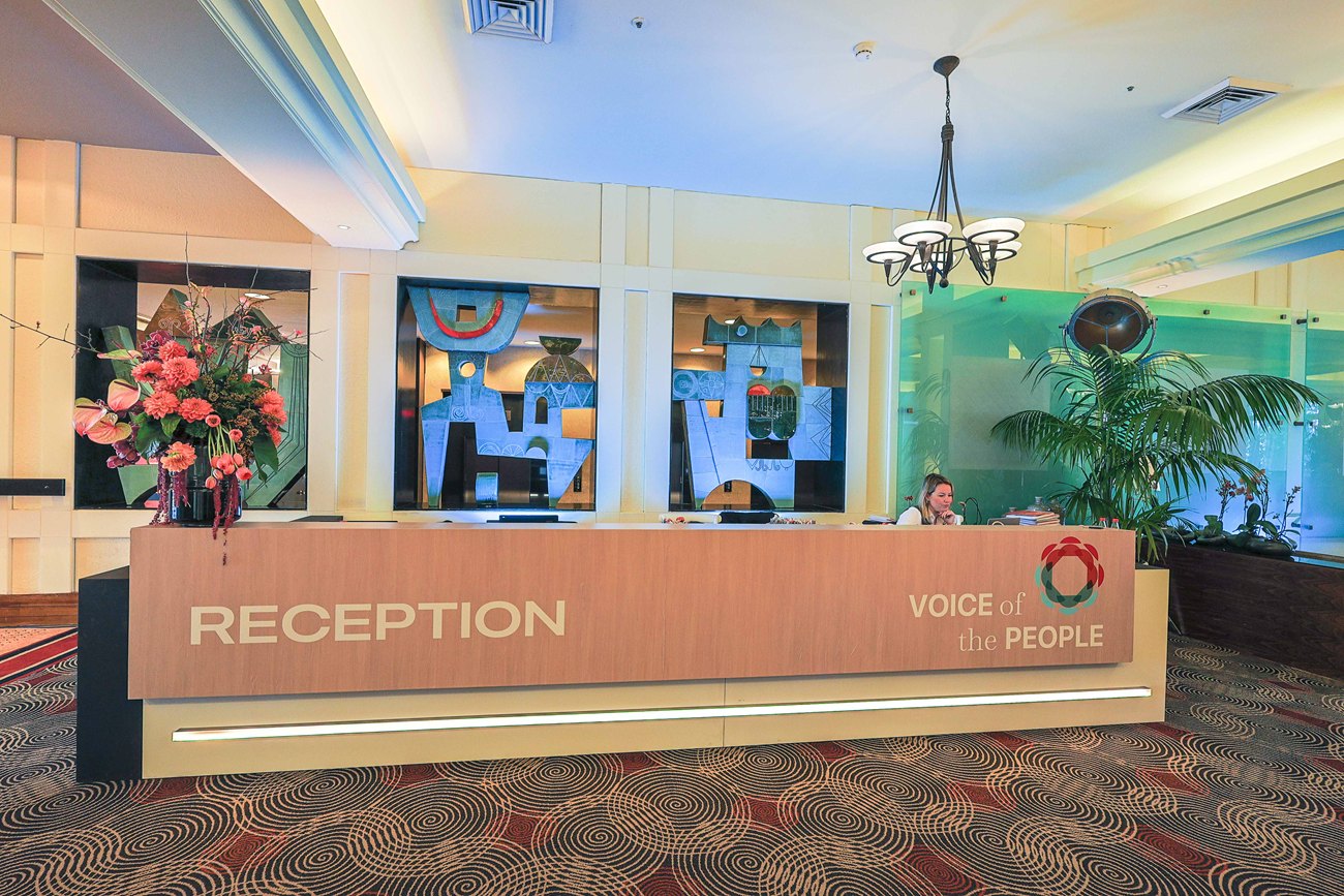 The reception counter built for the conference, its front carrying the word Reception and the project wordmark.